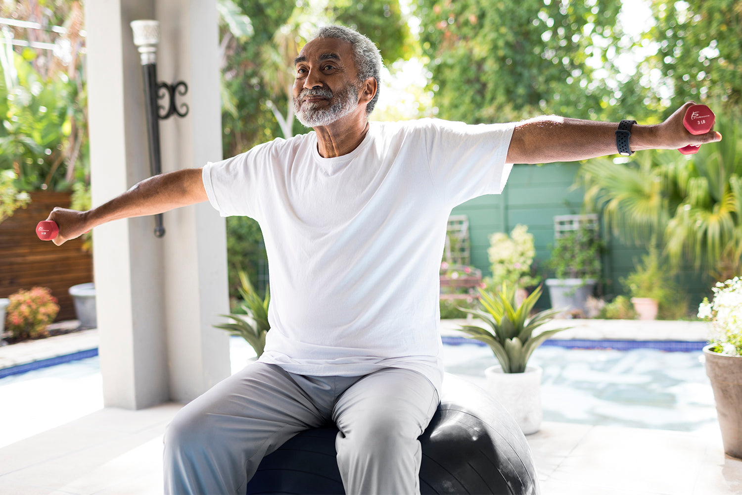 Senior man doing exercise on stability ball for balance