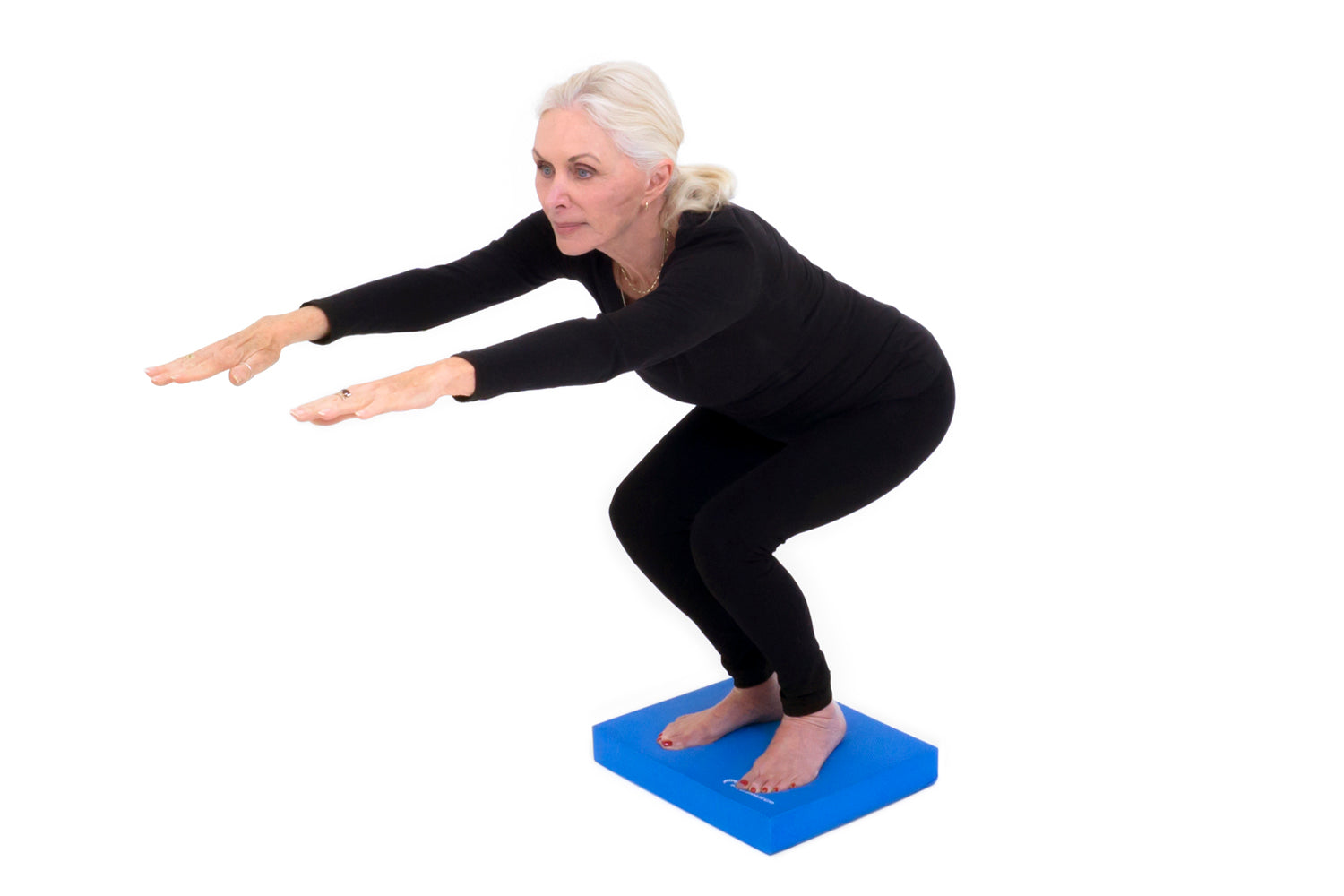 Senior balance exercise squat on balance pad