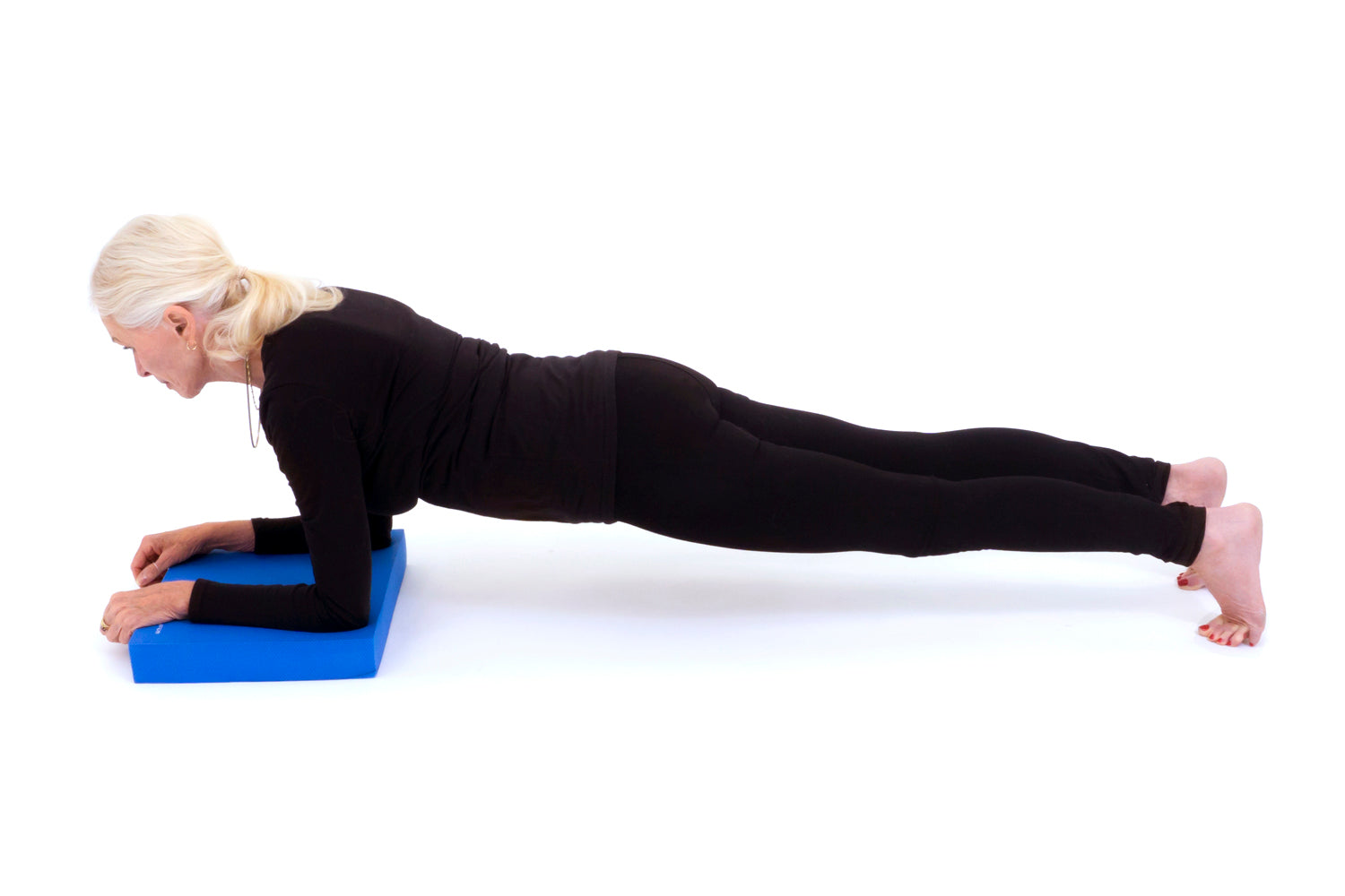 Woman doing plank on exercise balance pad