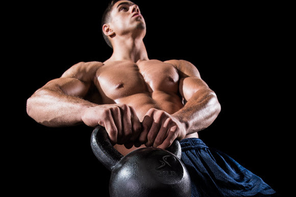 man holding prosourcefit cast iron kettlebell