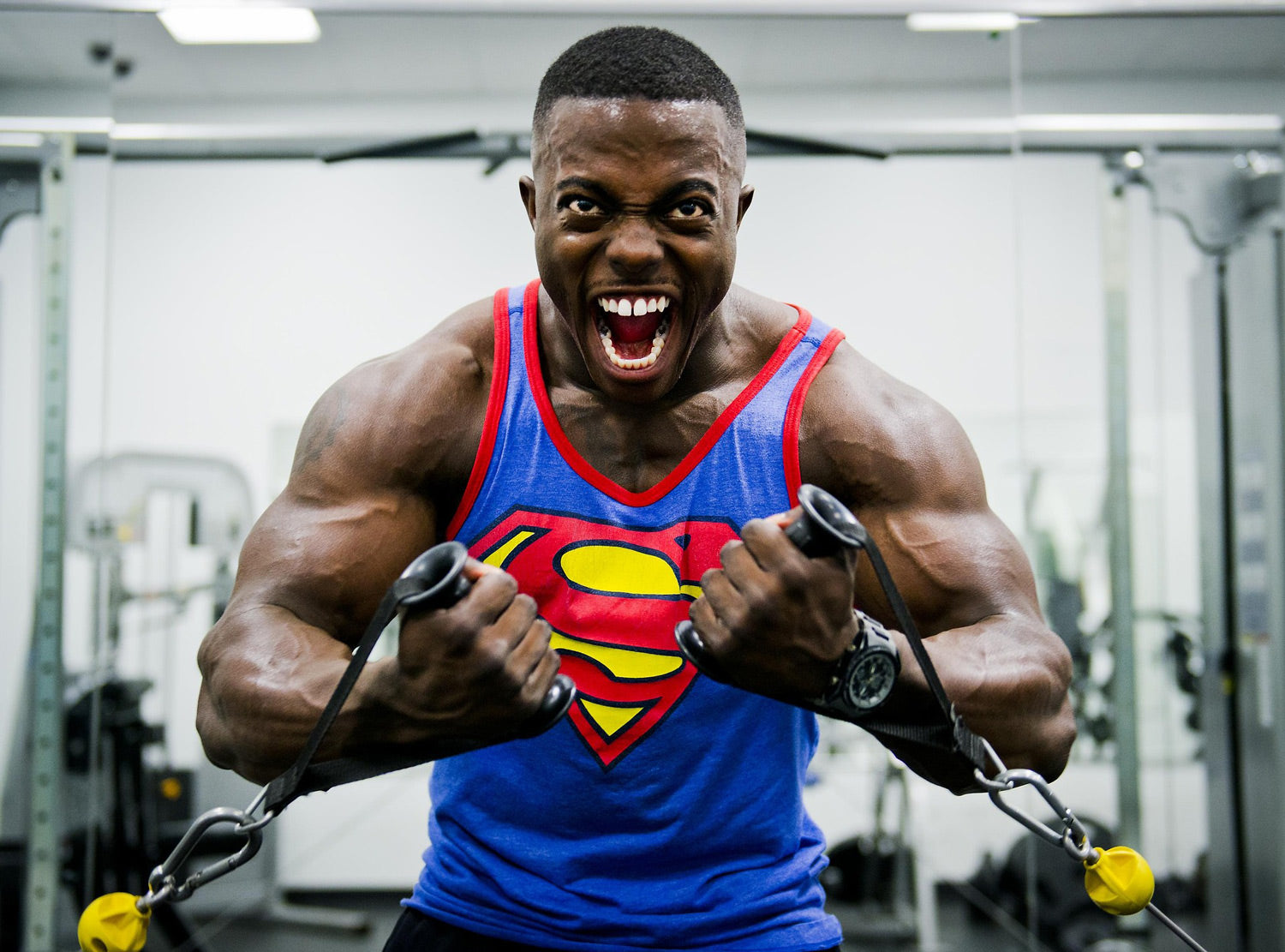 Muscular man in superman top working out