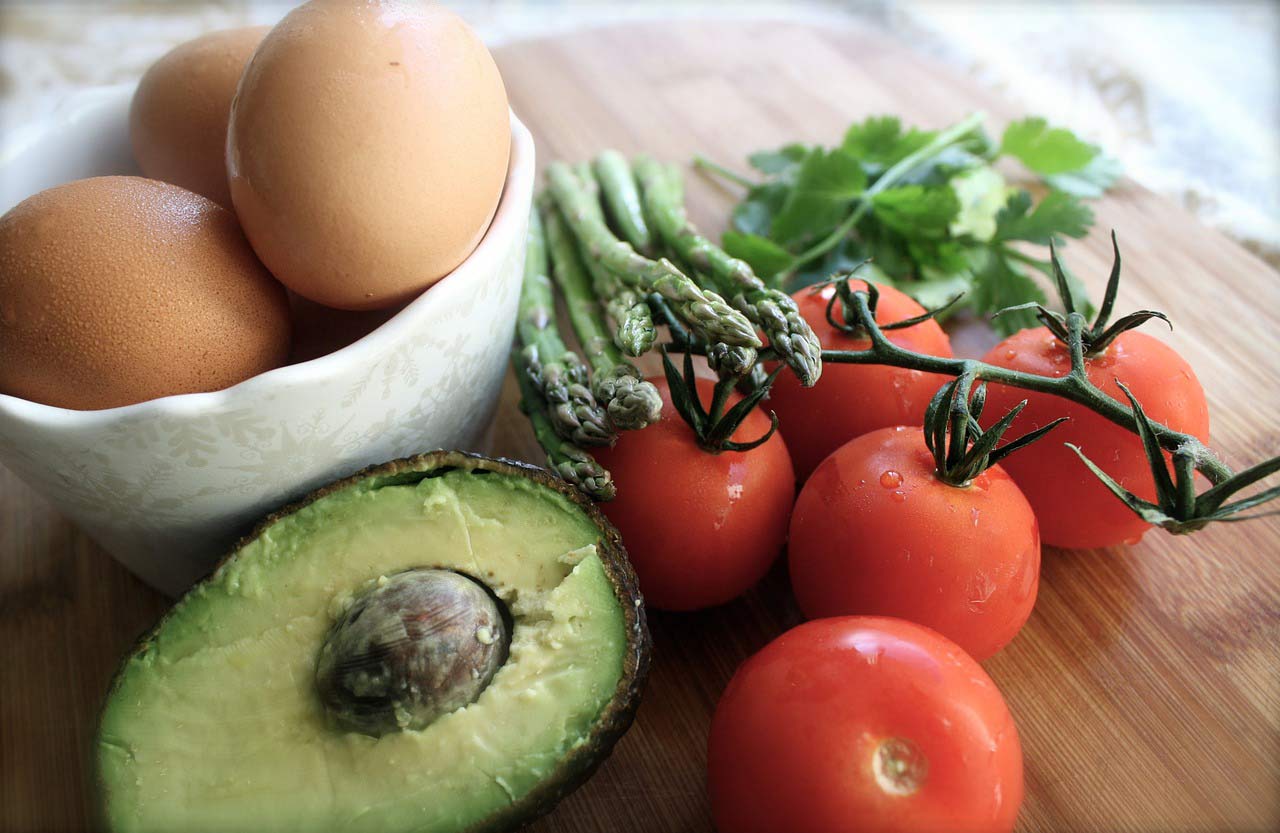 close up of eggs in bowl and avocado