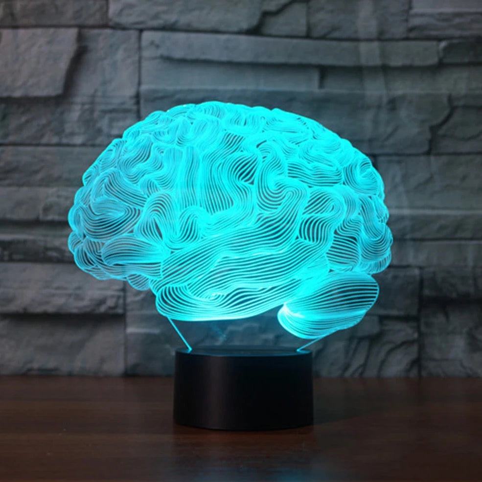 3D brain-shaped LED lamp with colour changing modes and remote control on wooden surface