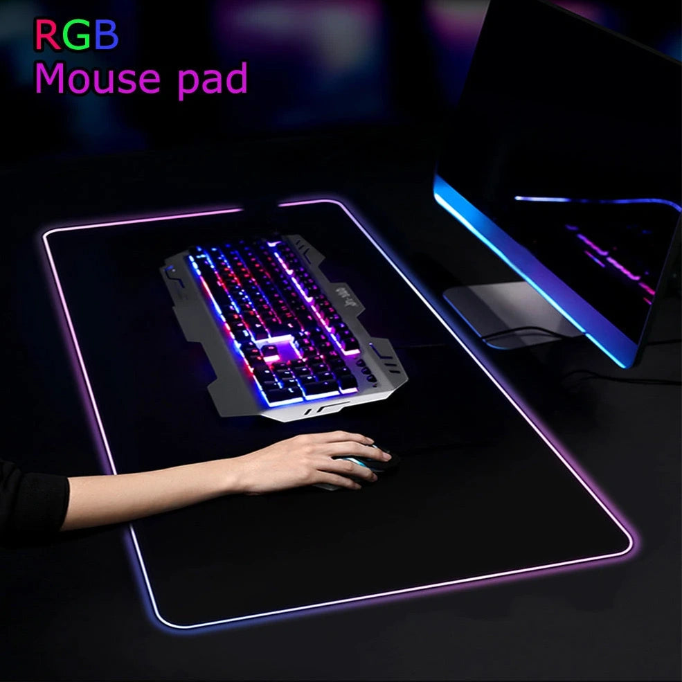 Black RGB gaming mouse pad with illuminated surface measuring 900x400mm and 4mm thickness