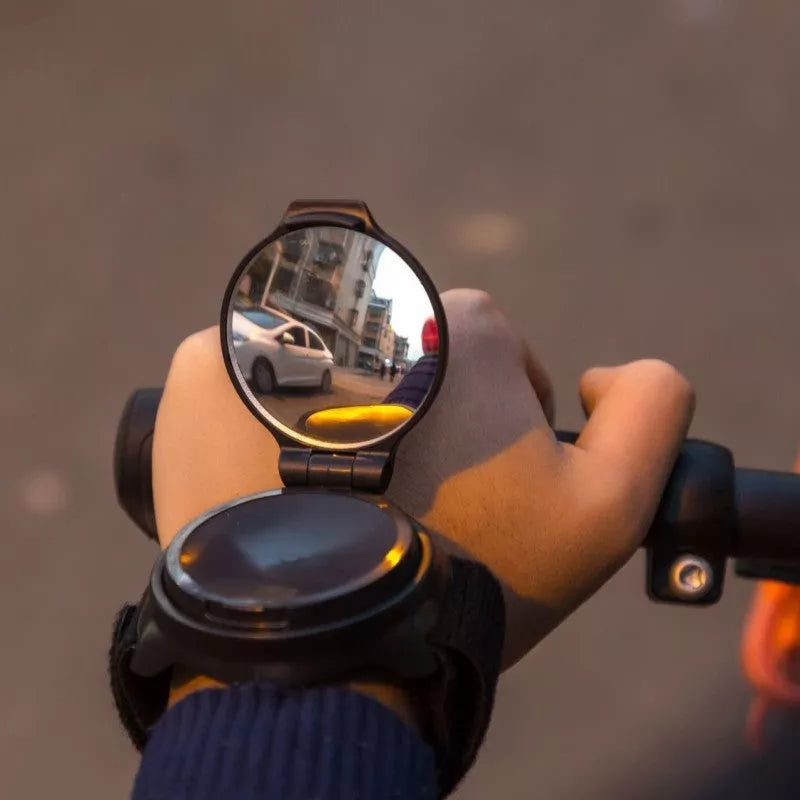 Wrist riding rear view mirror with 360° rotation