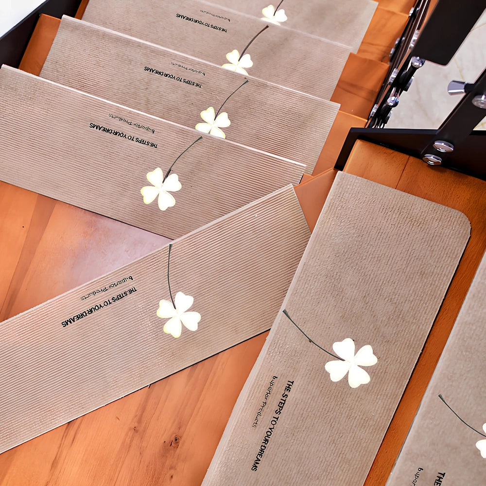 Self-adhesive luminous stair mat with glow strips on wooden staircase, rectangular design with hemmed edges