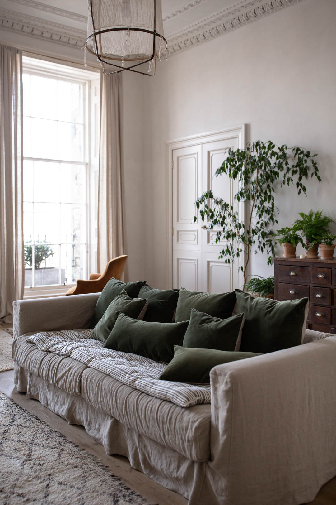 Linen sofa and dark green velvet cushion covers 