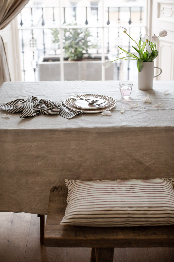 simple natural table setting with linen and stripe napkin 