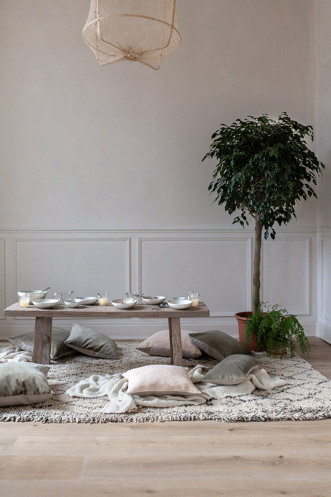 natural home decor with linen, wool, wood and plants 