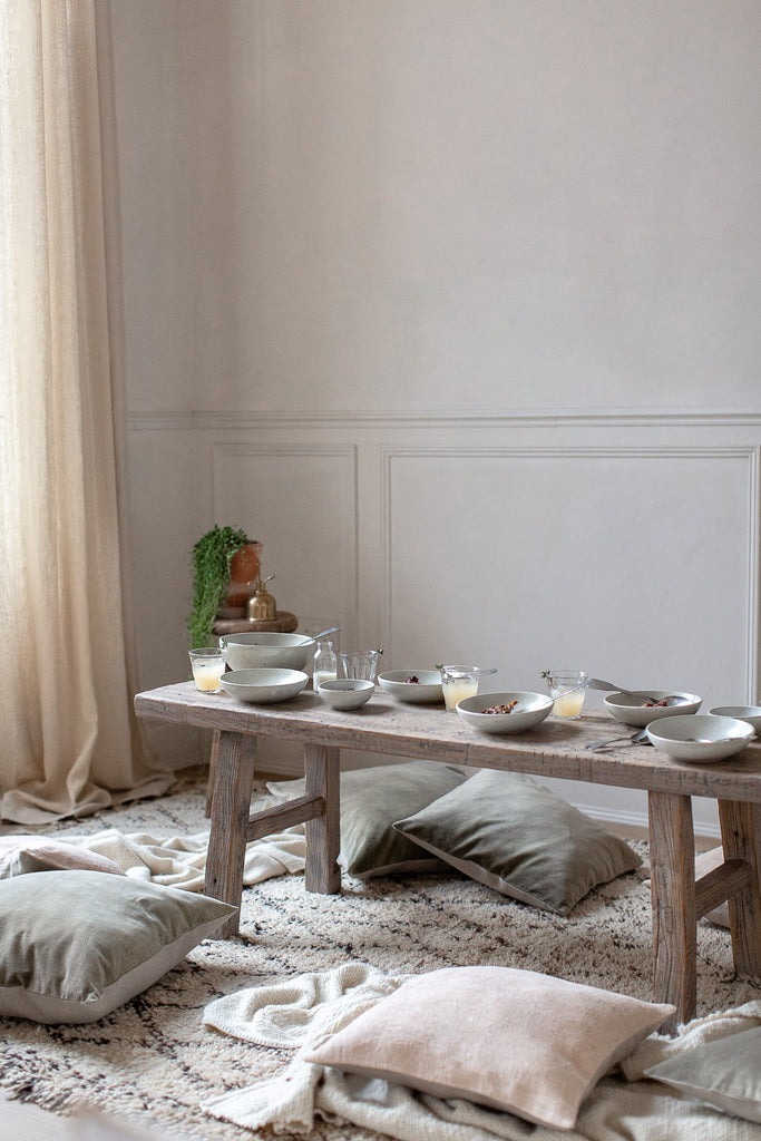 natural sunny breakfast table with linen, wood and wool