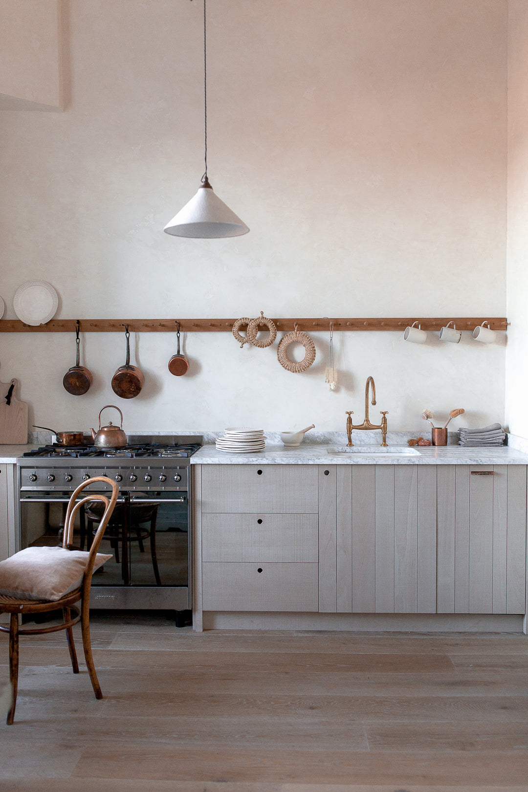plaster walls wooden kitchen with marble worktop