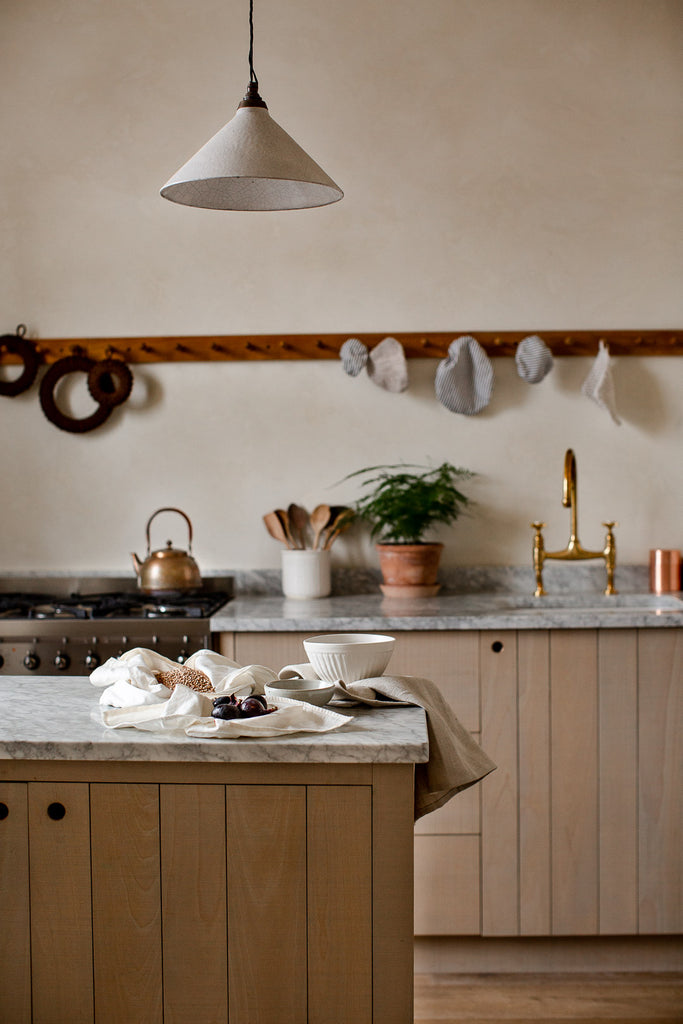 wooden kitchen with marble and cream venetian plaster walls 