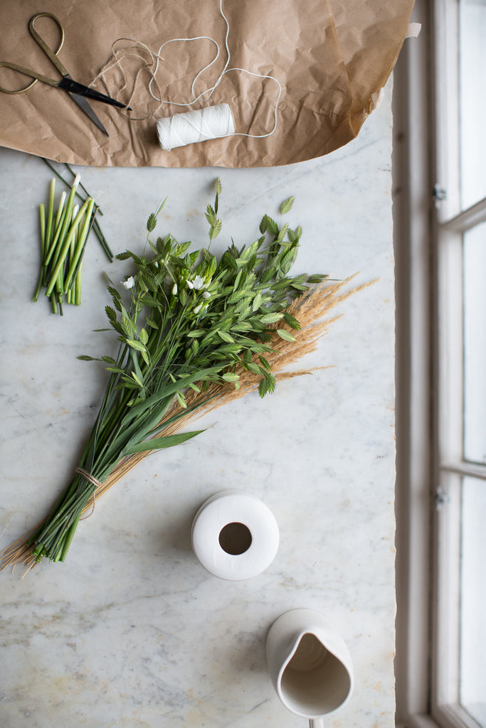 green flowers on a marble work top