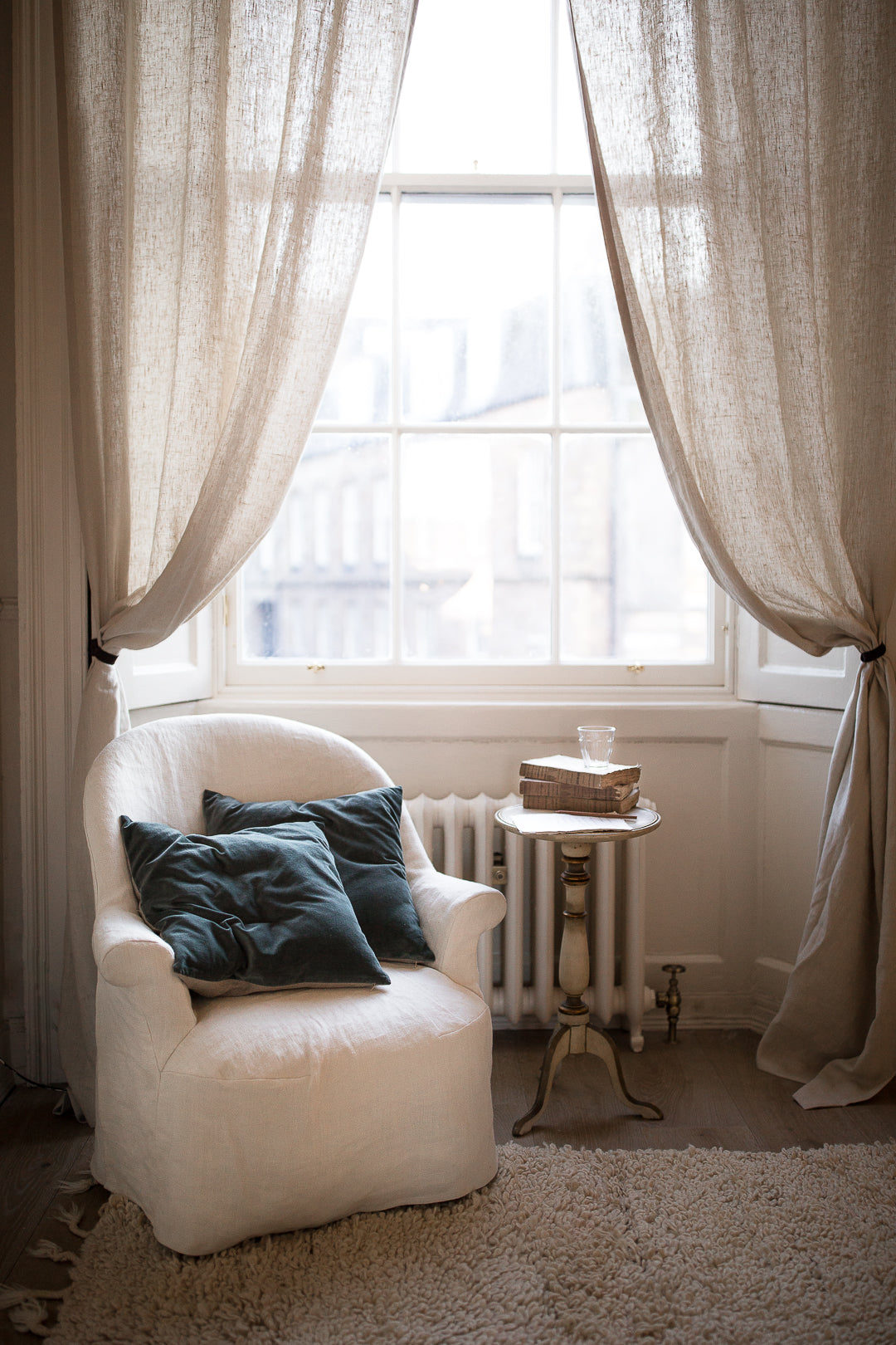 armchair velvet cushions by a big window