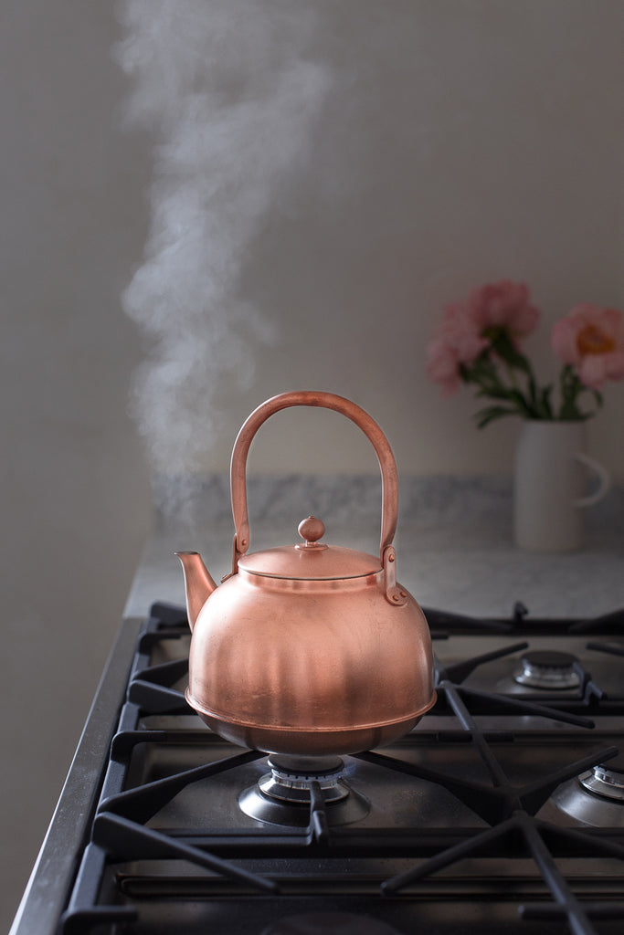 copper kettle with steam vapour 