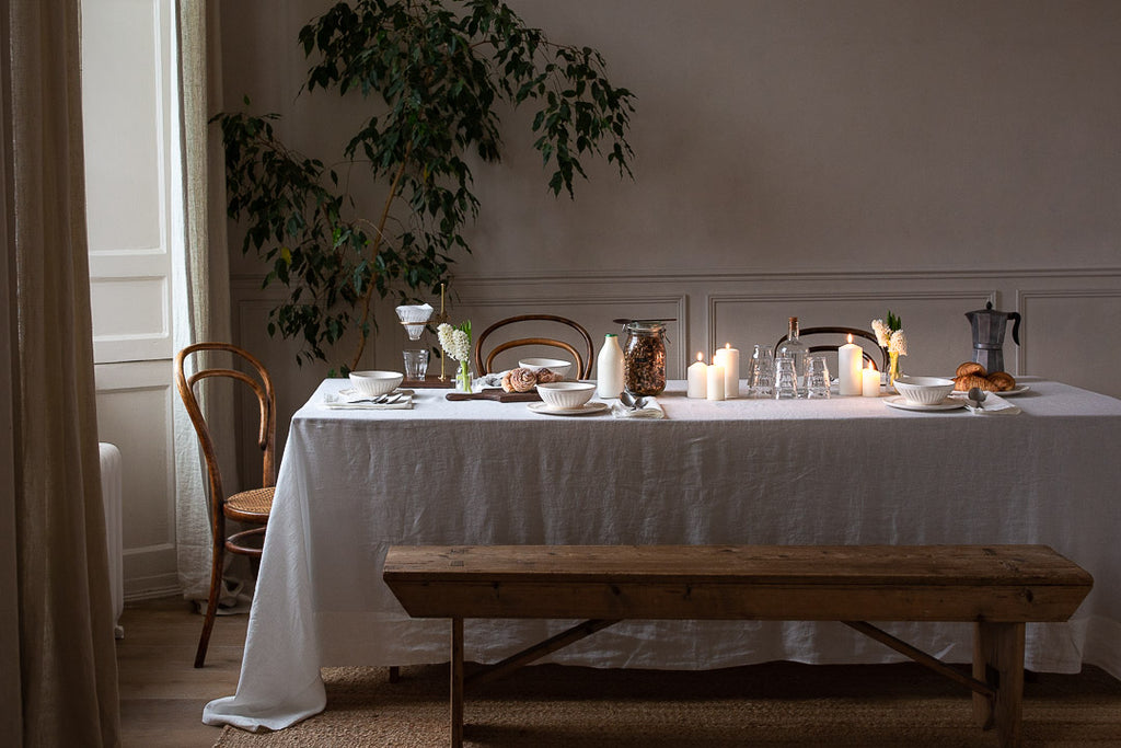 natural breakfast table setting with linen, plants and wood
