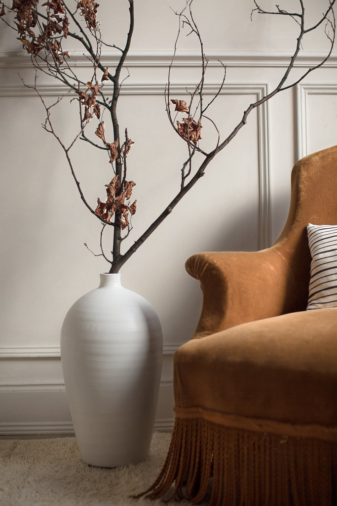 vintage velvet armchair and large branch vase