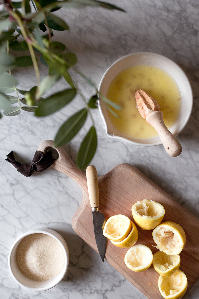 handmade ceramics and wooden chopping board on marble 