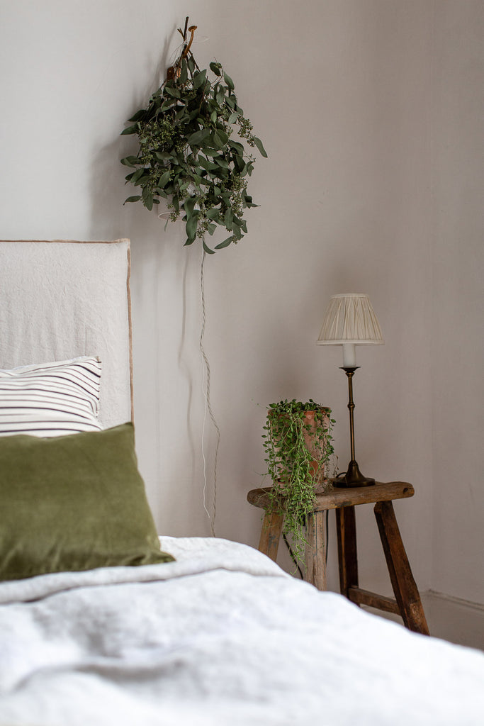 natural bedroom with linen in cream and green 