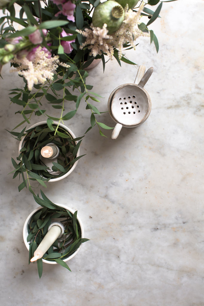 tea, candles and flowers on a marble table 