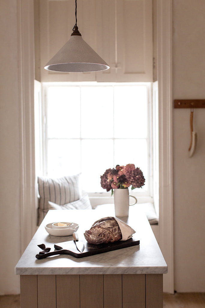 large kitchen window and marble top island 