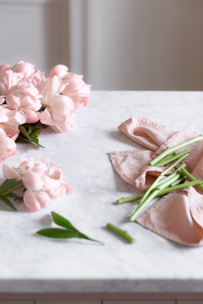 pink peonies, grey and white marble and pink linen 