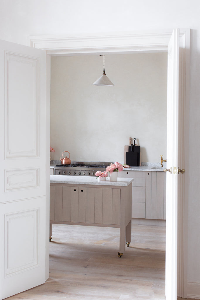 natural modern vintage kitchen with marble and plaster walls