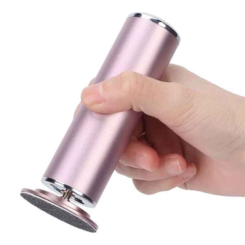 Woman using electric foot file to remove dead skin from heel at home