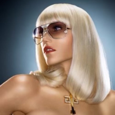 Gwen Stefani with an edgy hairstyle posing with her gold Dinero style sunglasses from Giant vintage