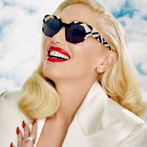 Gwen Stefani with red lipstick smiling looking up with her IMAGINE Mod Geometric Sunglasses from Giant Vintage