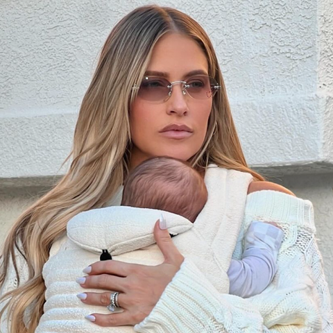 Blonde haired woman holding a baby in a carrier while wearing her trendy style sunglasses from the brand Giant Vintage