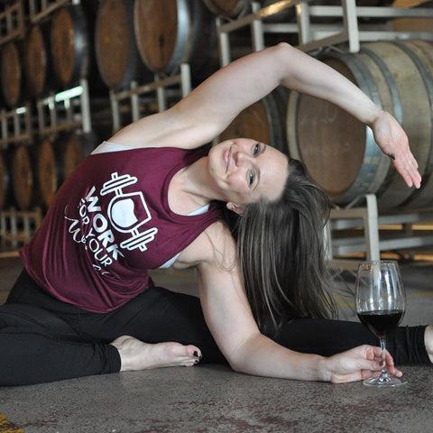 Woman drinking wine and doing yoga