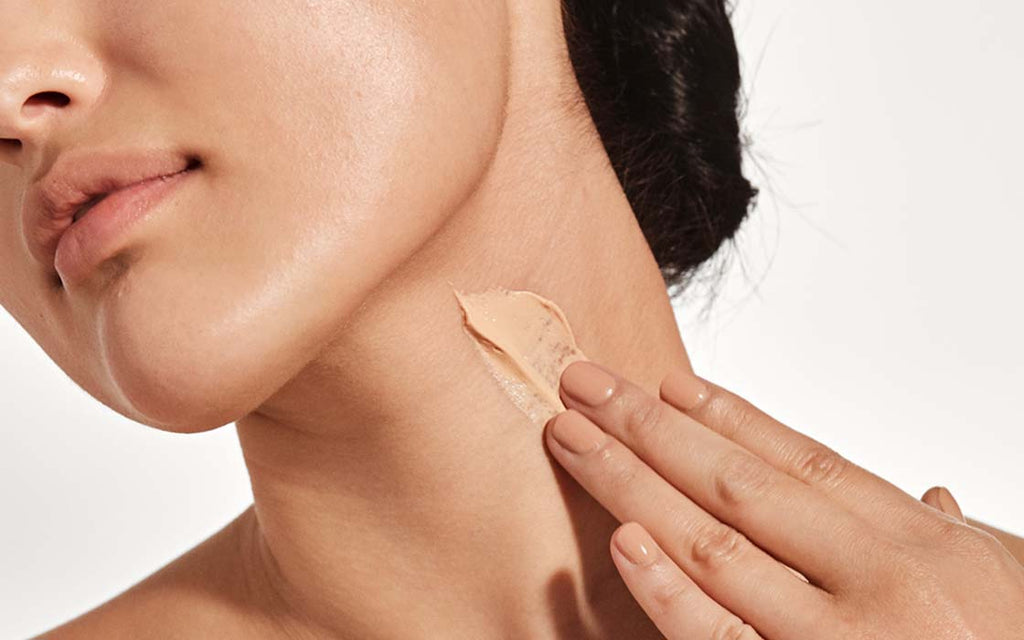 Applying skincare product on neck