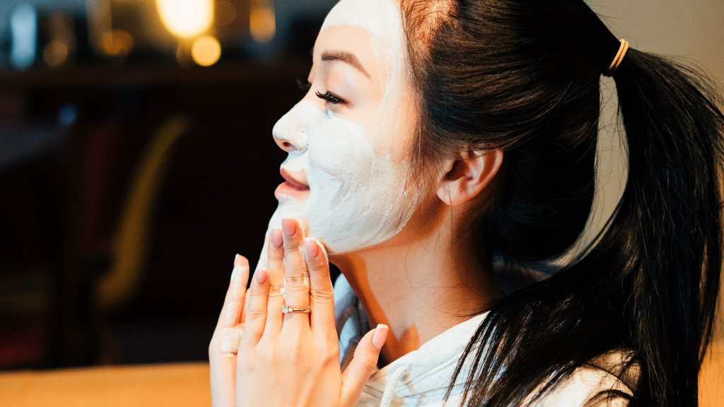 Girl Applying Clay Mask On Face