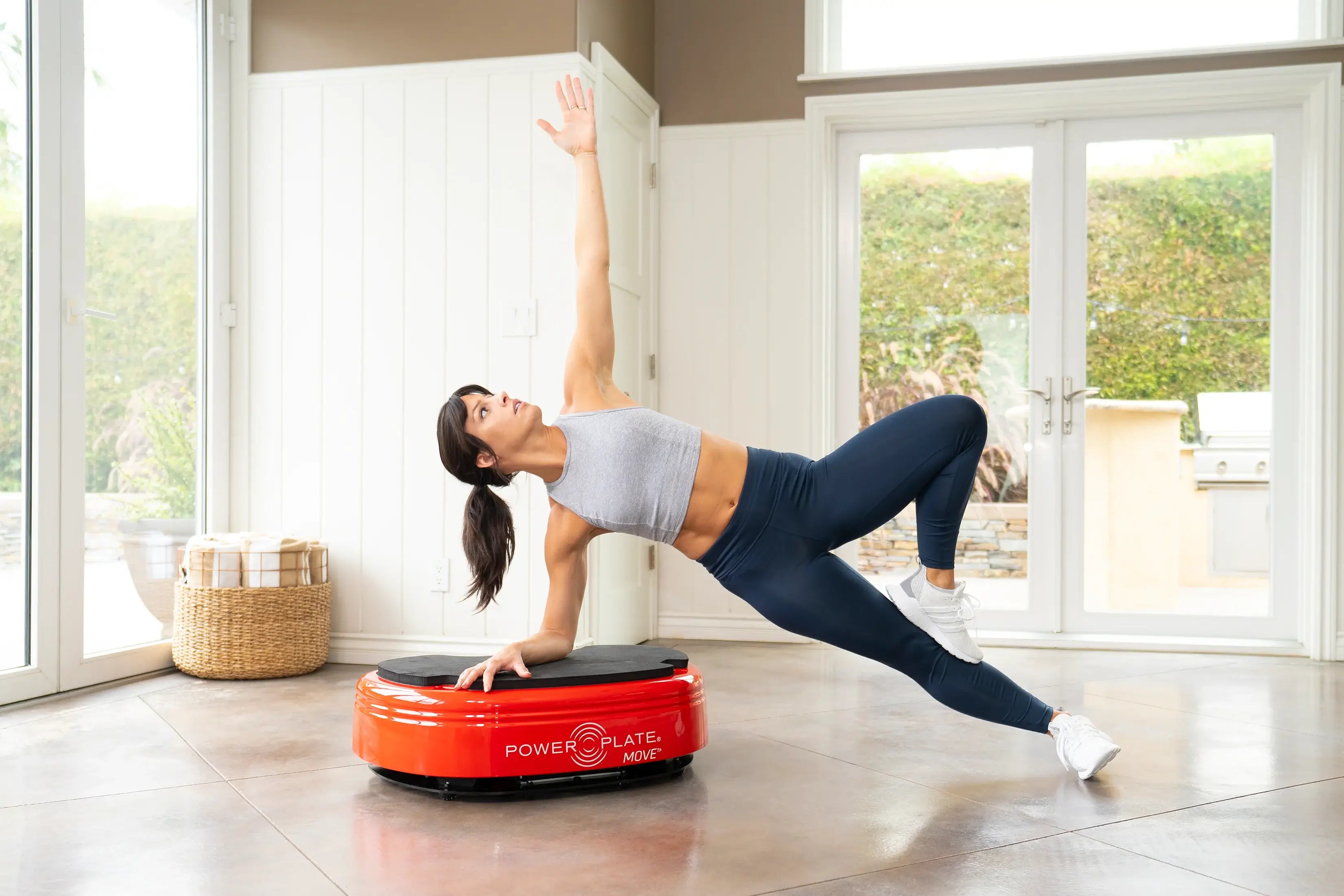 Woman exercising using Power Plate® MOVE at home