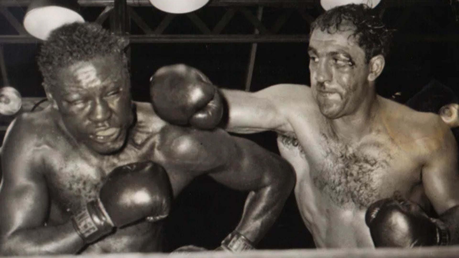 Rocky Marciano stops Ezzard Charles in rematch.