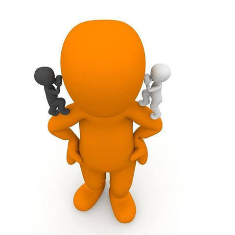 Orange model of a human with a black human figure on one shoulder and on the other shoulder a white human figure both whispering in the ear of the main figure. 