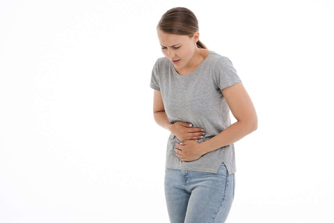 woman holding stomach representing IBS pain