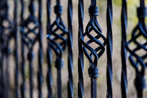 Wrought iron fence with twisted open pattern all painted in black