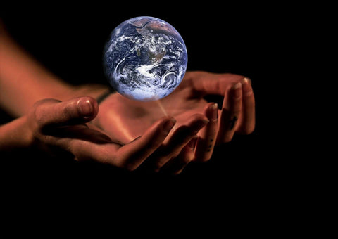 Picture is of a glass world hovering over open hands of a human