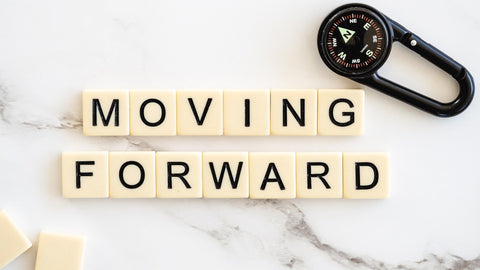 image of tiles spelling the words moving forward