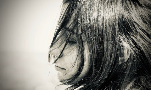 profile picture of a young woman with wind swept hair, looking relaxed