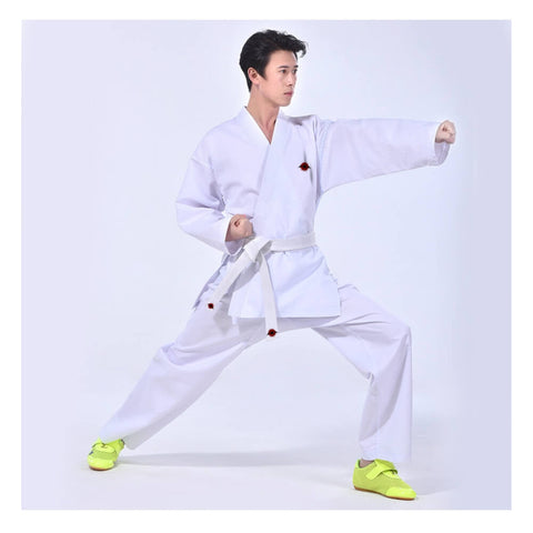 A man wearing a white 9.5oz Kumite Karate Uniform sold by 100 Spartans