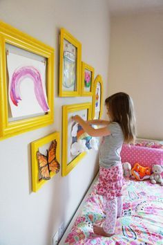child hanging artwork