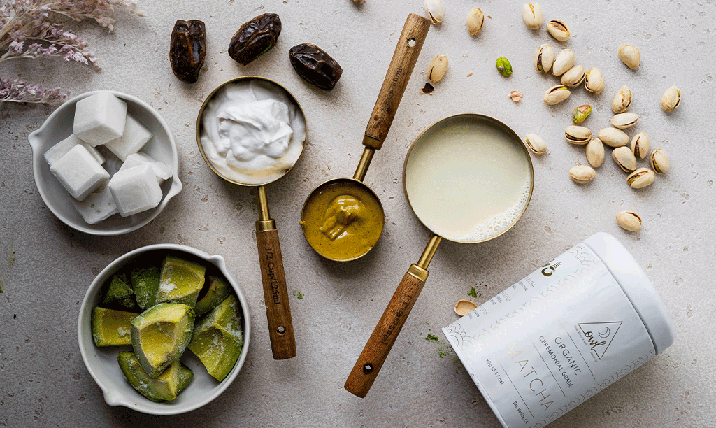avocado, coconut yogurt, pistachio butter, pistachios, OWL Matcha Powder, and dates on the counter