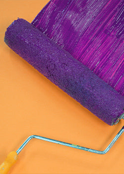 Purple paint going over an orange wall 