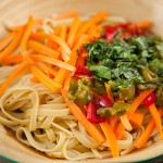Add your fettuccini pasta, chopped peppers, carrots, and basil. Stir well until all combined.