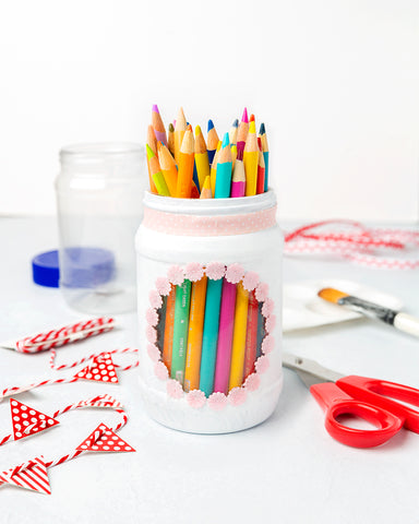 Empty Peanut Butter Jar Repurposed Into a Pencil Holder Filled with Colored Pencils