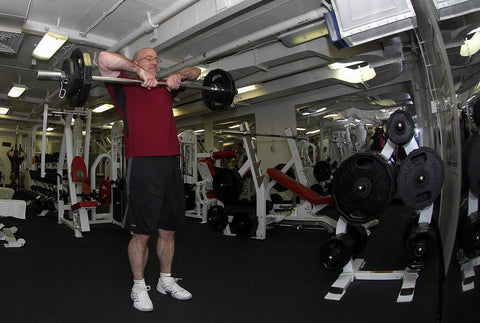 Bone Health as You Age - Older man lifting weights at the gym