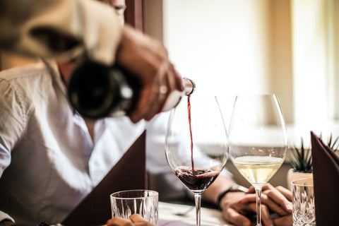 Cardiovascular Health - Person pouring a glass of red wine